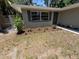 Lush front yard with mulched flower beds and landscape lighting, adding charm and appeal at 1461 17Th St, Sarasota, FL 34234
