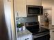 Modern kitchen with stainless steel appliances, granite countertops, and stylish backsplash at 1461 17Th St, Sarasota, FL 34234