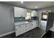 Kitchen featuring granite counters, stainless sink, white cabinets, and stainless appliances at 1461 17Th St, Sarasota, FL 34234
