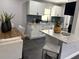 Modern kitchen and dining area featuring granite countertops and white cabinets at 1461 17Th St, Sarasota, FL 34234
