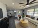 Cozy living room featuring modern ceiling fan, neutral furniture, open floor plan, and lots of natural light at 1461 17Th St, Sarasota, FL 34234