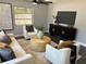Bright living room showcases neutral tones, elegant furnishings, and a contemporary entertainment setup at 1461 17Th St, Sarasota, FL 34234