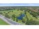 Aerial view of park featuring a small pond, soccer field, and surrounding green space with trees at 15032 Skip Jack Loop, Lakewood Ranch, FL 34202