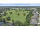 An aerial view features a park with soccer fields, pond, and school in the distance at 15032 Skip Jack Loop, Lakewood Ranch, FL 34202