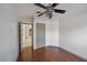 Comfortable bedroom features hardwood floors, a ceiling fan, and a closet for ample storage at 15032 Skip Jack Loop, Lakewood Ranch, FL 34202