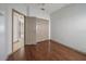 Bedroom view with wood floors, closet, and view into next room at 15032 Skip Jack Loop, Lakewood Ranch, FL 34202