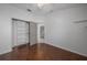 Bedroom with hardwood floors, an open door, large closet, and ceiling fan at 15032 Skip Jack Loop, Lakewood Ranch, FL 34202