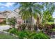 Charming home with lush landscaping, tropical plants, and a well-manicured lawn at 15032 Skip Jack Loop, Lakewood Ranch, FL 34202