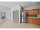 Kitchen features stainless steel refrigerator and wooden cabinets at 15032 Skip Jack Loop, Lakewood Ranch, FL 34202