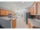 Modern kitchen with wooden cabinets, stainless steel appliances, and tile flooring at 15032 Skip Jack Loop, Lakewood Ranch, FL 34202