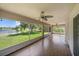 This screened lanai offers tile floors, ceiling fans, and views of the lawn and lake at 15032 Skip Jack Loop, Lakewood Ranch, FL 34202
