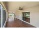 A spacious screened lanai with wood-look tile floor and views of the lawn and lake at 15032 Skip Jack Loop, Lakewood Ranch, FL 34202