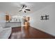 Bright living room features hardwood floors and open floorplan that connects to the kitchen at 15032 Skip Jack Loop, Lakewood Ranch, FL 34202