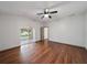 Main bedroom boasts hardwood floors, a ceiling fan, and access to the patio at 15032 Skip Jack Loop, Lakewood Ranch, FL 34202