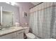 Charming bathroom with granite countertop, a full mirror, and a shower featuring a decorative curtain at 15719 Barefoot Beach Dr, Lakewood Ranch, FL 34211