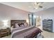 Bedroom with wood-look floors, a ceiling fan, and a large dresser at 15719 Barefoot Beach Dr, Lakewood Ranch, FL 34211
