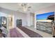 Bedroom with decorative ceiling fan, wood-look flooring, and large dresser with television at 15719 Barefoot Beach Dr, Lakewood Ranch, FL 34211