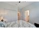 A calming bedroom with a ceiling fan, closet, and an ensuite bathroom at 15719 Barefoot Beach Dr, Lakewood Ranch, FL 34211