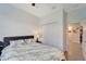 A calming bedroom with a ceiling fan, closet, and ensuite bathroom at 15719 Barefoot Beach Dr, Lakewood Ranch, FL 34211