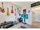 Bonus room featuring guitars on the wall, a TV and an open doorway at 15719 Barefoot Beach Dr, Lakewood Ranch, FL 34211