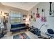 Bonus room featuring musical instruments, a TV, a black couch and a window with blinds at 15719 Barefoot Beach Dr, Lakewood Ranch, FL 34211