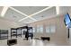 Modern gym with cross-fit equipment, weights, and wall-mounted TV near shuttered windows at 15719 Barefoot Beach Dr, Lakewood Ranch, FL 34211