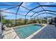 Screened-in pool and jacuzzi with a clear view of the water and surrounding homes at 15719 Barefoot Beach Dr, Lakewood Ranch, FL 34211
