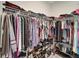 Spacious walk-in closet with ample storage, metal shelving, hanging rods and shoe racks at 15719 Barefoot Beach Dr, Lakewood Ranch, FL 34211