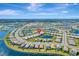 Lush aerial view of a well-manicured community featuring cozy homes, tranquil lakes, and beautifully landscaped streets at 15719 Barefoot Beach Dr, Lakewood Ranch, FL 34211