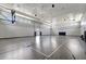 Spacious indoor basketball court featuring high ceilings, multiple hoops, and clearly marked lines for games and practice at 15719 Barefoot Beach Dr, Lakewood Ranch, FL 34211