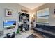 Room featuring guitars and a sofa, perfect for a music enthusiast at 15719 Barefoot Beach Dr, Lakewood Ranch, FL 34211