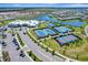 Overhead showcases the community's tennis courts, clubhouse, pools, lakes, and more, offering a diverse range of recreational options at 15719 Barefoot Beach Dr, Lakewood Ranch, FL 34211