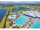 Aerial shot showcases community pools, courts, and more, offering various recreational options amidst lush greenery and serene lakes at 15719 Barefoot Beach Dr, Lakewood Ranch, FL 34211