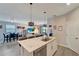 Kitchen featuring a central island with granite countertop, stainless appliances, and a view to the living area at 15719 Barefoot Beach Dr, Lakewood Ranch, FL 34211