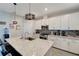 Kitchen with granite island, stainless steel appliances, and modern pendant lighting at 15719 Barefoot Beach Dr, Lakewood Ranch, FL 34211
