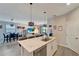 View of the kitchen with a large island, stainless steel appliances and an open floor plan to the living room and dining area at 15719 Barefoot Beach Dr, Lakewood Ranch, FL 34211