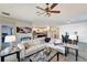 Open-concept living room and kitchen with white leather sofa and neutral color scheme at 15719 Barefoot Beach Dr, Lakewood Ranch, FL 34211
