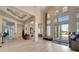Elegant lobby with high ceilings, ample natural light, modern furnishings, and clear signage for directions and information at 15719 Barefoot Beach Dr, Lakewood Ranch, FL 34211