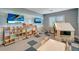 Colorful playroom with shelves of toys, a playhouse, table and chairs, and televisions for entertainment at 15719 Barefoot Beach Dr, Lakewood Ranch, FL 34211