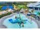 Vibrant water park featuring colorful slides, interactive water features, and ample seating for a fun-filled community experience at 15719 Barefoot Beach Dr, Lakewood Ranch, FL 34211