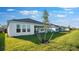 Well-maintained backyard featuring lush green grass and a view of the home's exterior at 1599 Laurel Brook Ln, Port Charlotte, FL 33953