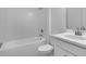 This bathroom features a clean, white bathtub with tiled walls, along with a modern toilet and sink at 1599 Laurel Brook Ln, Port Charlotte, FL 33953