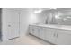 A well-lit bathroom with a long vanity, double sinks, and a walk-in shower at 1599 Laurel Brook Ln, Port Charlotte, FL 33953