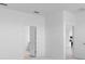 Neutral bedroom with white walls and doors, and doorway leading into another room at 1599 Laurel Brook Ln, Port Charlotte, FL 33953