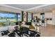 Bright living room with views of the lake, modern furniture, and access to outdoor living space at 1599 Laurel Brook Ln, Port Charlotte, FL 33953