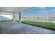 Covered patio overlooking a serene lake view and lush greenery, perfect for outdoor relaxation at 1599 Laurel Brook Ln, Port Charlotte, FL 33953