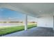 Enjoy the view from this covered patio, overlooking a serene lake and community landscape at 1599 Laurel Brook Ln, Port Charlotte, FL 33953