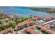 An aerial view of a multi-Gathering condo complex with a nearby tennis court and water views at 1624 Stickney Point Rd # 24-206, Sarasota, FL 34231
