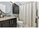 Bathroom featuring a dark vanity with granite countertop and neutral shower curtain at 1624 Stickney Point Rd # 24-206, Sarasota, FL 34231
