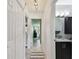 Hallway leads to a stylish bathroom with a dark vanity and granite countertop at 1624 Stickney Point Rd # 24-206, Sarasota, FL 34231